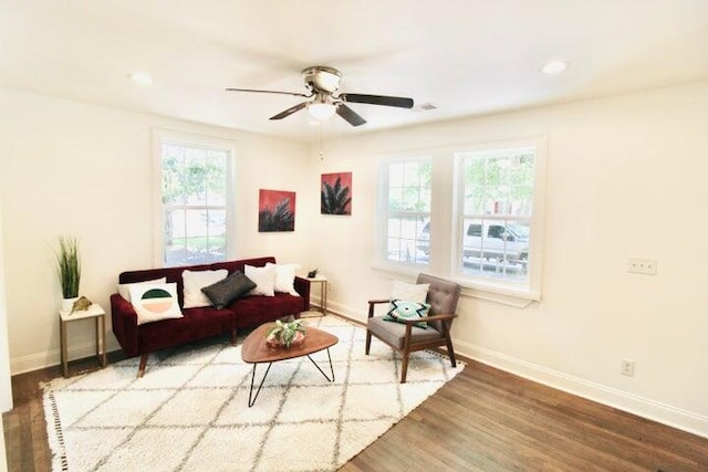 living room featuring hardwood / wood-style floors and ceiling fan