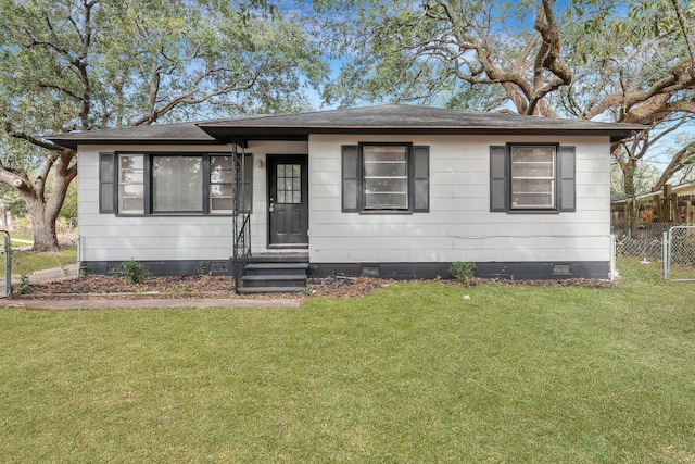 view of front of house with a shingled roof, entry steps, crawl space, fence, and a front lawn