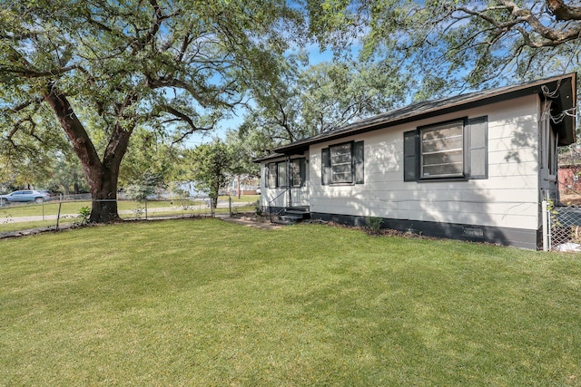 exterior space featuring entry steps, crawl space, fence, and a lawn