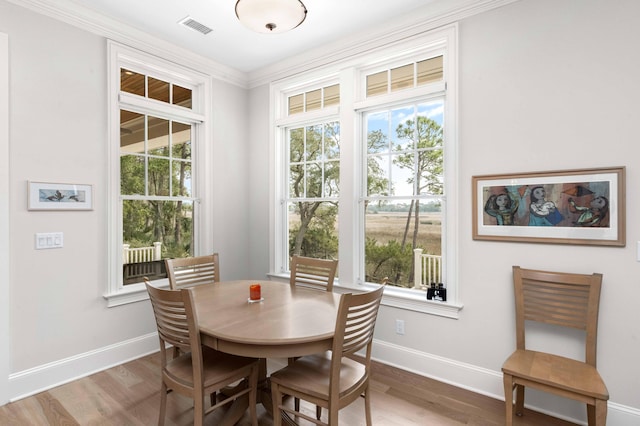 dining room with visible vents, baseboards, and wood finished floors