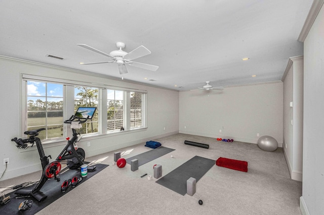 exercise room with visible vents, baseboards, carpet, and ornamental molding