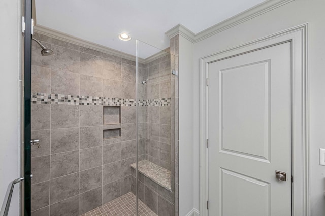 bathroom with a shower stall and crown molding