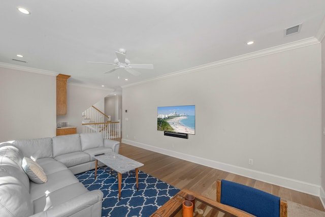 living room with visible vents, wood finished floors, recessed lighting, baseboards, and stairs