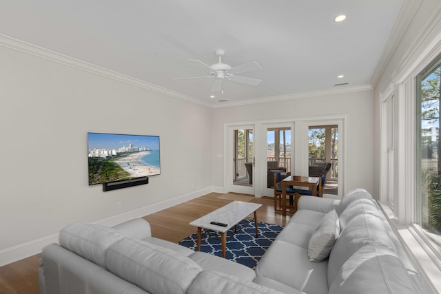 living area featuring recessed lighting, wood finished floors, baseboards, and ornamental molding