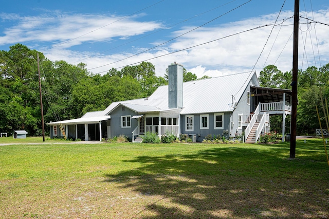 225 Baxter Ln, Walterboro, SC 29488 - back of property featuring a sunroom, stairway, a chimney, and a lawn