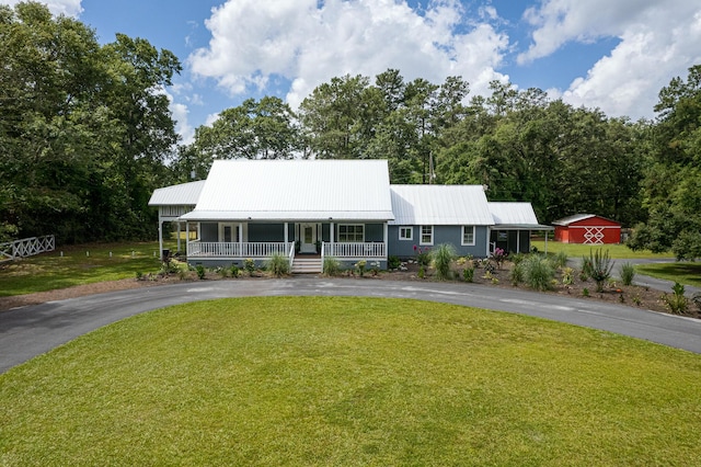 225 Baxter Ln, Walterboro, SC 29488 - view of front of house featuring covered porch, curved driveway, a front yard, and metal roof