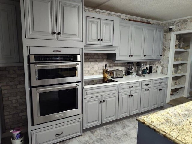 225 Baxter Ln, Walterboro, SC 29488 - kitchen featuring stainless steel double oven, black electric cooktop, crown molding, light countertops, and a textured ceiling
