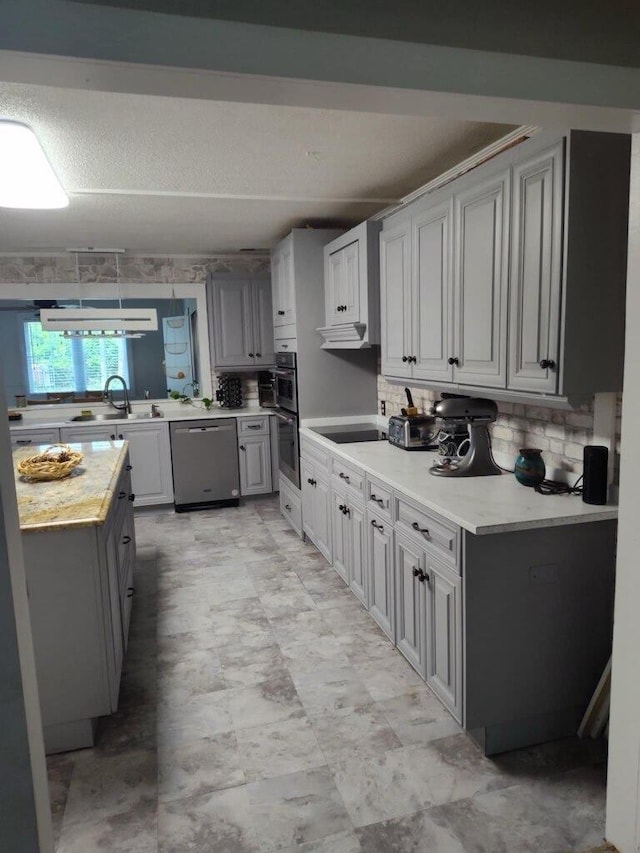 225 Baxter Ln, Walterboro, SC 29488 - kitchen featuring stainless steel appliances, a sink, gray cabinetry, light countertops, and tasteful backsplash