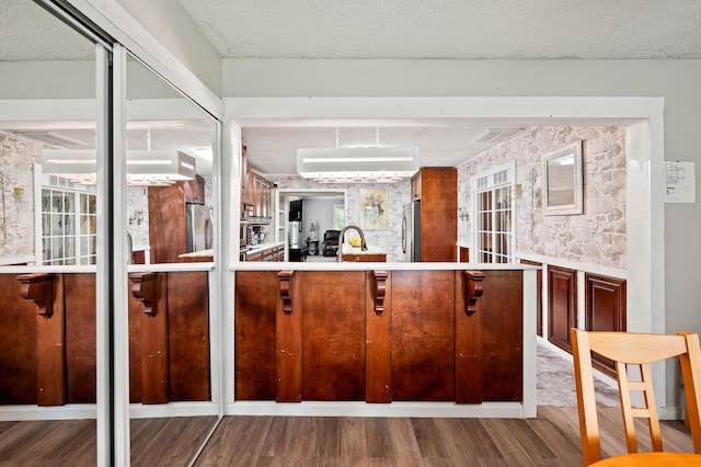 225 Baxter Ln, Walterboro, SC 29488 - kitchen featuring stainless steel refrigerator, wood finished floors, freestanding refrigerator, a sink, and a textured ceiling