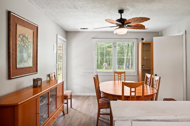 225 Baxter Ln, Walterboro, SC 29488 - dining room featuring light wood-style flooring, ceiling fan, a textured ceiling, and baseboards