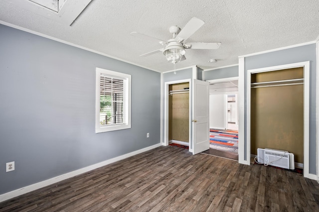 225 Baxter Ln, Walterboro, SC 29488 - unfurnished bedroom featuring crown molding, multiple closets, dark wood-type flooring, a textured ceiling, and baseboards