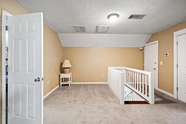 225 Baxter Ln, Walterboro, SC 29488 - additional living space featuring a textured ceiling, carpet floors, vaulted ceiling, and baseboards