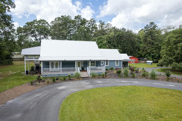 225 Baxter Ln, Walterboro, SC 29488 - farmhouse inspired home featuring curved driveway, covered porch, a front yard, and metal roof