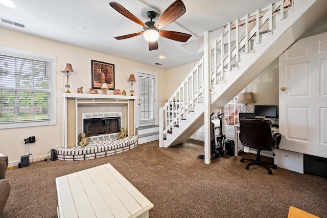 225 Baxter Ln, Walterboro, SC 29488 - carpeted home office with a ceiling fan, a brick fireplace, a textured ceiling, and baseboards