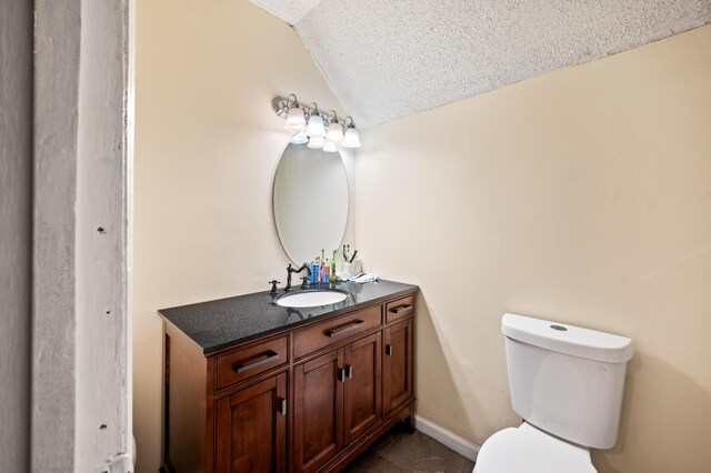 225 Baxter Ln, Walterboro, SC 29488 - bathroom with vaulted ceiling, toilet, vanity, tile patterned floors, and a textured ceiling