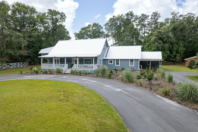 225 Baxter Ln, Walterboro, SC 29488 - view of front of house featuring driveway, covered porch, a front lawn, and metal roof
