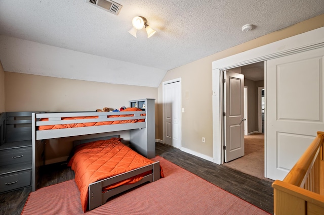 225 Baxter Ln, Walterboro, SC 29488 - bedroom with wood finished floors, a textured ceiling, baseboards, and vaulted ceiling