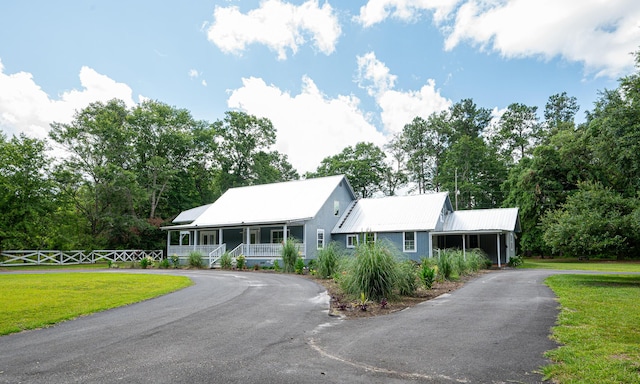 225 Baxter Ln, Walterboro, SC 29488 - view of front of house with driveway, covered porch, metal roof, and view of scattered trees