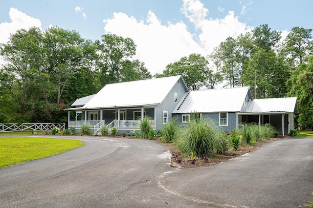 225 Baxter Ln, Walterboro, SC 29488 - view of front of home with driveway, covered porch, metal roof, and fence