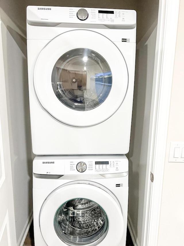 laundry room with stacked washer and clothes dryer