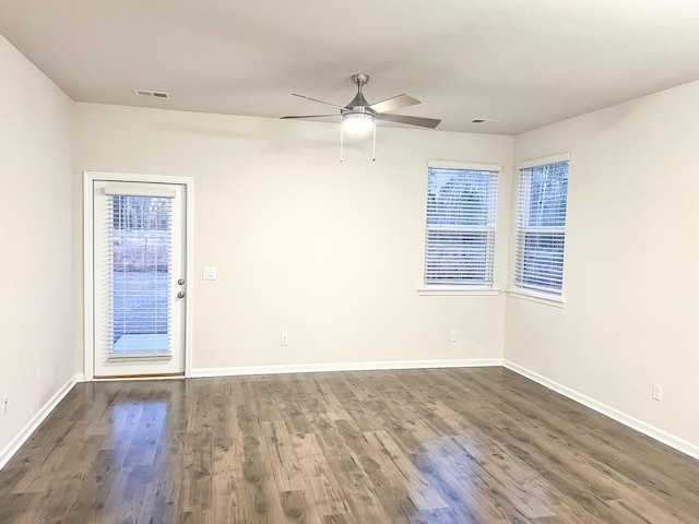 empty room featuring ceiling fan and dark wood-type flooring