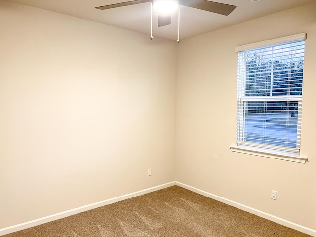 empty room with ceiling fan and carpet floors