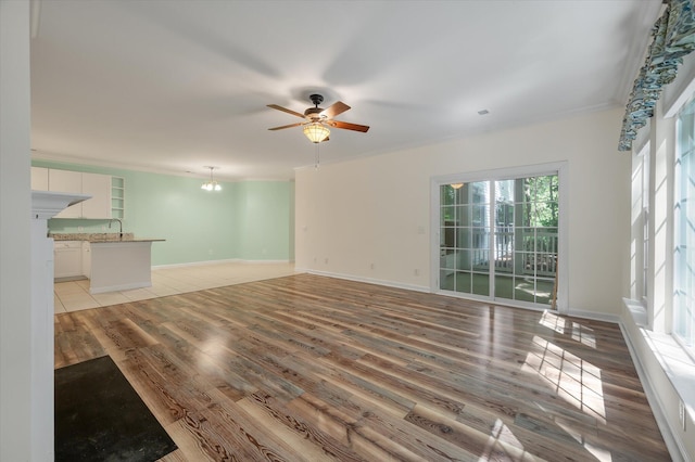 115 Golfview Ln, Summerville, SC 29485 - unfurnished living room featuring light wood finished floors, a ceiling fan, a sink, and baseboards