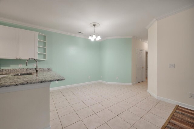 115 Golfview Ln, Summerville, SC 29485 - kitchen with a sink, a chandelier, light stone counters, ornamental molding, and white cabinetry