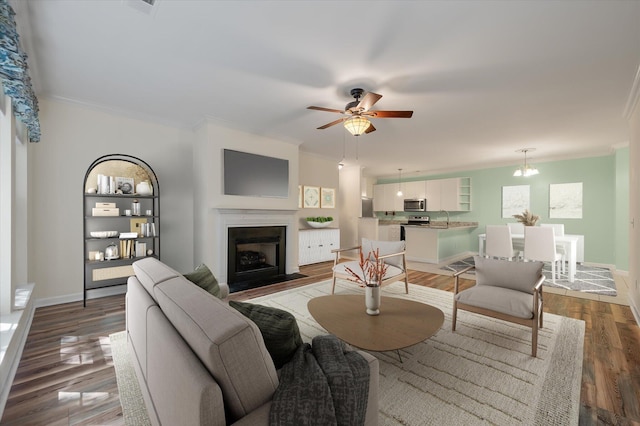 115 Golfview Ln, Summerville, SC 29485 - living room with crown molding, ceiling fan, a fireplace with flush hearth, light wood-type flooring, and baseboards