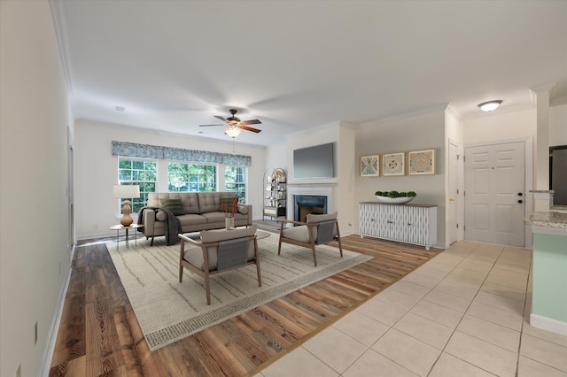 115 Golfview Ln, Summerville, SC 29485 - living room featuring ceiling fan, a fireplace, crown molding, tile patterned floors, and baseboards