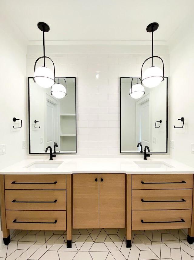 bathroom with vanity, tile patterned floors, and tasteful backsplash