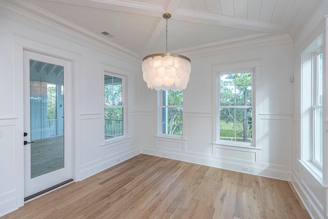 unfurnished dining area with plenty of natural light, a notable chandelier, and light hardwood / wood-style flooring