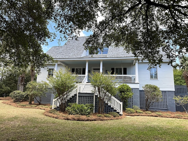 view of front of property with stairway, a front yard, a porch, and roof with shingles