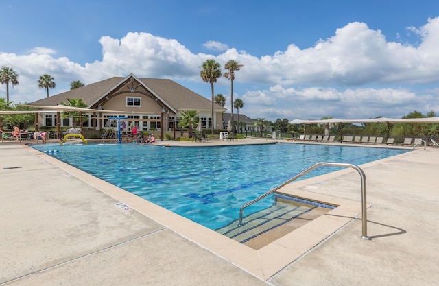community pool featuring a patio and fence