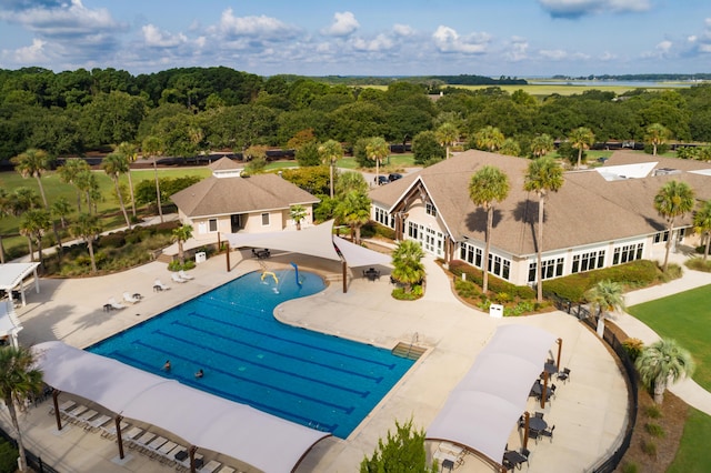 swimming pool with a patio and a water view