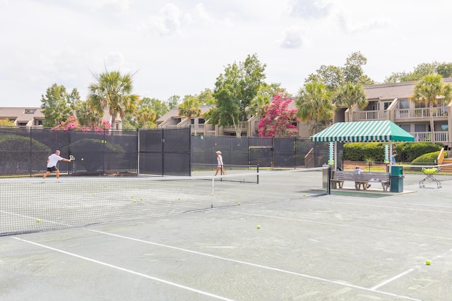 view of tennis court featuring fence