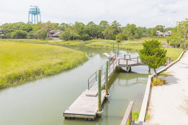 dock area with a water view and view of wooded area