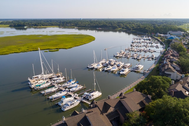 drone / aerial view of a nearby body of water and a marina
