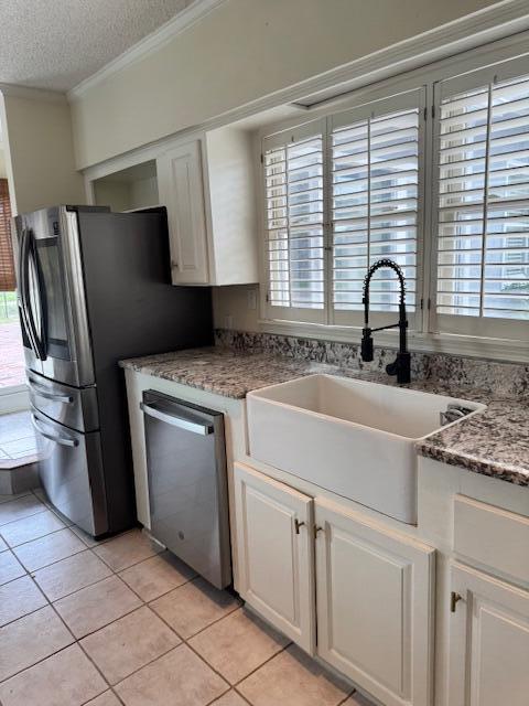 1129 Levi St, Manning, SC 29102 - kitchen featuring dishwasher, a sink, crown molding, white cabinets, and a textured ceiling