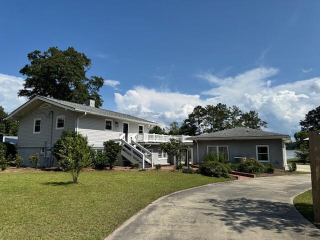 1129 Levi St, Manning, SC 29102 - view of front of house featuring a front lawn, stairs, and concrete driveway