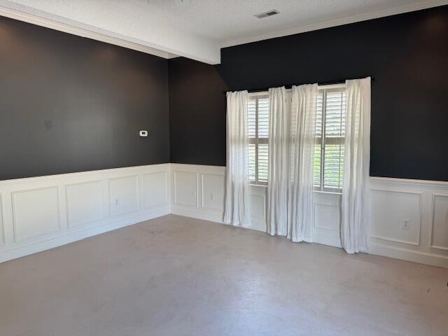 1129 Levi St, Manning, SC 29102 - spare room with a decorative wall, wainscoting, and ornamental molding