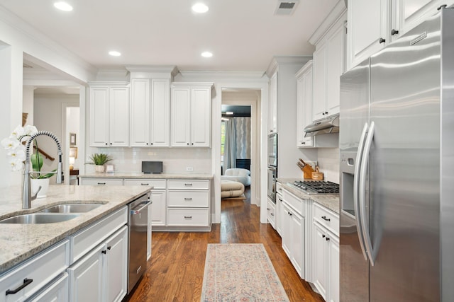 1407 Wando View St, Daniel Island, SC 29492 - kitchen with stainless steel appliances, white cabinetry, dark wood-type flooring, decorative backsplash, and recessed lighting
