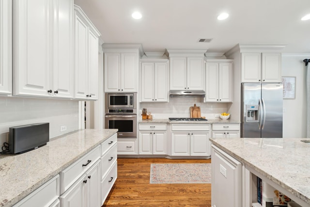 1407 Wando View St, Daniel Island, SC 29492 - kitchen featuring appliances with stainless steel finishes, white cabinetry, wood finished floors, and recessed lighting