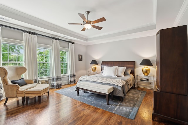 1407 Wando View St, Daniel Island, SC 29492 - bedroom with multiple windows, a tray ceiling, wood finished floors, ornamental molding, and ceiling fan
