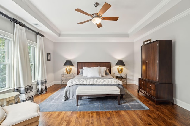 1407 Wando View St, Daniel Island, SC 29492 - bedroom featuring a tray ceiling, wood finished floors, crown molding, and a ceiling fan