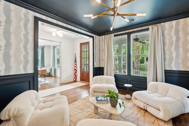 1407 Wando View St, Daniel Island, SC 29492 - living room with ornamental molding, a chandelier, wood finished floors, and wainscoting