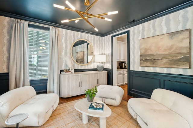 1407 Wando View St, Daniel Island, SC 29492 - living area with a chandelier, wainscoting, a decorative wall, and wood finished floors