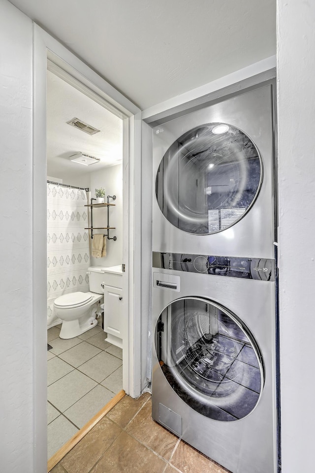 2174 Bees Ferry Rd Unit G, Charleston, SC 29414 - laundry room with estacked washer and dryer and tile patterned floors