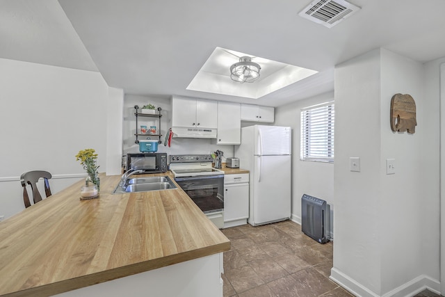 2174 Bees Ferry Rd Unit G, Charleston, SC 29414 - kitchen featuring white appliances, wood counters, under cabinet range hood, white cabinetry, and a tray ceiling