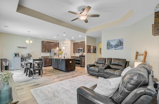 living area with light wood-type flooring, a ceiling fan, visible vents, and recessed lighting